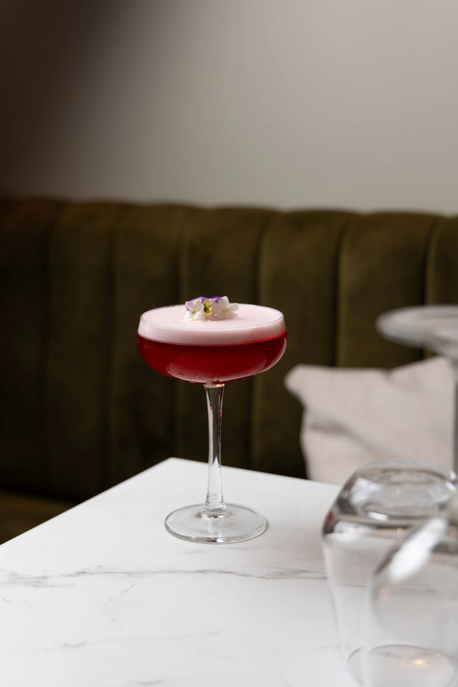 Signature cocktail with an edible flower, Maison Zue bar in Saumur